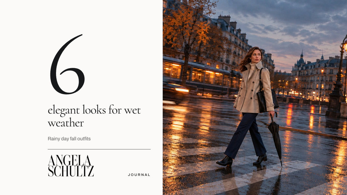 Woman in a short stone trench with a raised collar and navy ankle-length trousers crossing a wet street at dusk