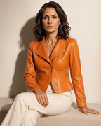 Women's Faux Leather Moto Jacket with Zip Front in Emma Orange, 03 seated or leaning, worn by model