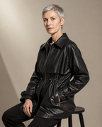 Women's Belted Leather-Look Trench Coat for Everyday Layering in Black, 03 seated or leaning, worn by model