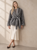 Warm editorial room · Soft sophisticated / old money Grey seated or lean