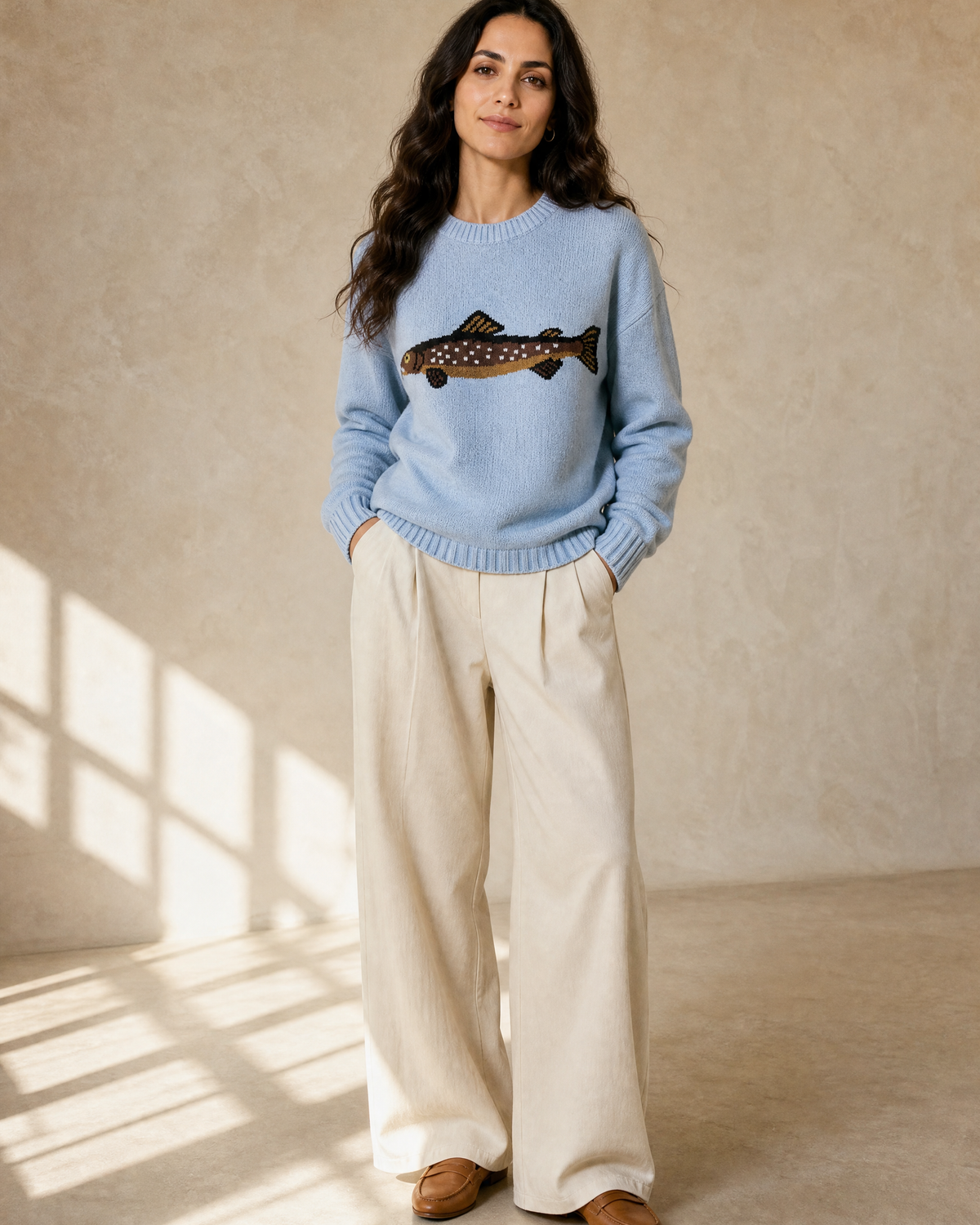 Women's Relaxed Fish Motif Knit Sweater in Blue, hands in pockets, worn by model