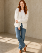 Women's Fuzzy Button Cardigan with Patch Pockets in White, loose arm cross, worn by model