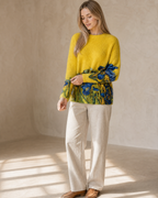 Women's Multicolour Patterned Crew Neck Sweater in Bright Yellow, adjusting the sleeve, worn by model