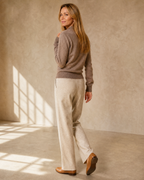 Women's Wrap V-Neck Knit Sweater for Everyday Layering in Original velvet color, walking away, glance back, worn by model