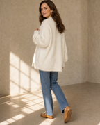 Women's V-Neck Button Cardigan with Pockets in White, walking away, glance back, worn by model