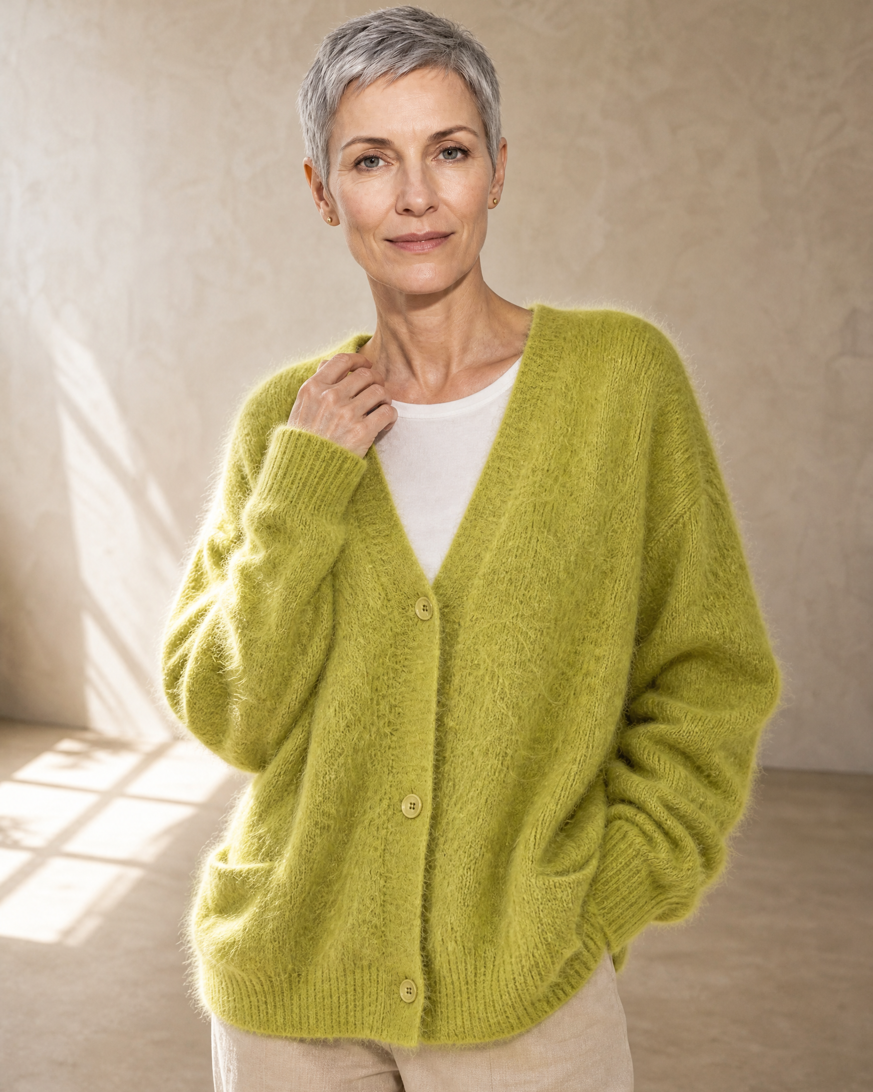 Women's V-Neck Button Cardigan with Pockets in Matcha green, one hand at collar, worn by model