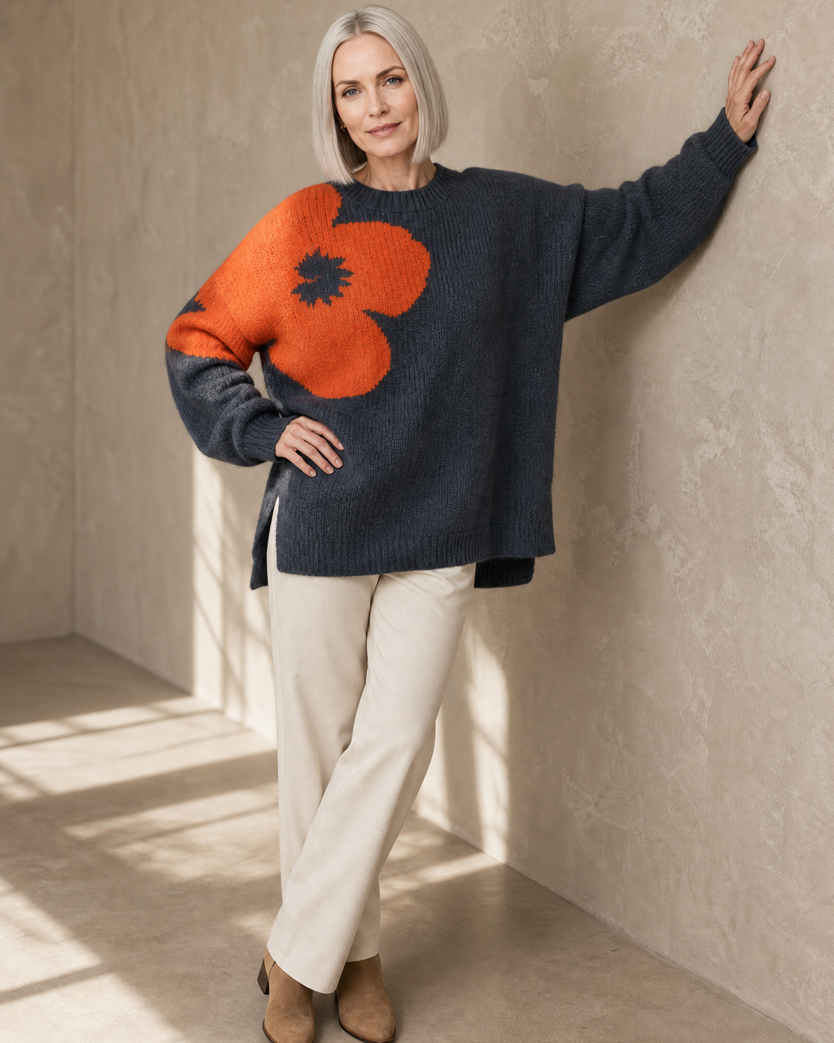 Women's Fashionable Pullover Sweater Top in Charcoal, forearm on wall, worn by model