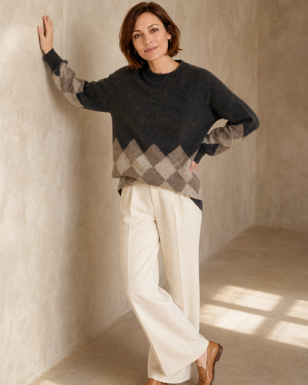 Women's Colour Block Argyle Knit Sweater in Dark Gray, forearm on wall, worn by model