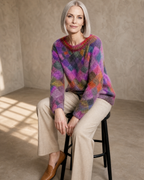 Women's Multicolour Patterned Crew Neck Sweater in Square, stool, forearms on thighs, worn by model