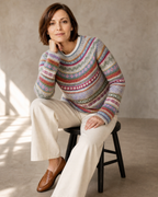 Women's Multicolour Patterned Crew Neck Sweater in Purple, stool, elbow on knee, worn by model
