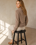 Women's Wrap V-Neck Knit Sweater for Everyday Layering in Original velvet color, stool, back turned, worn by model