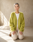 Women's V-Neck Button Cardigan with Pockets in Matcha green, kneeling upright, worn by model