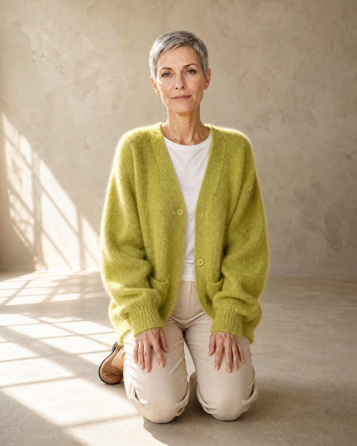 Women's V-Neck Button Cardigan with Pockets in Matcha green, kneeling upright, worn by model