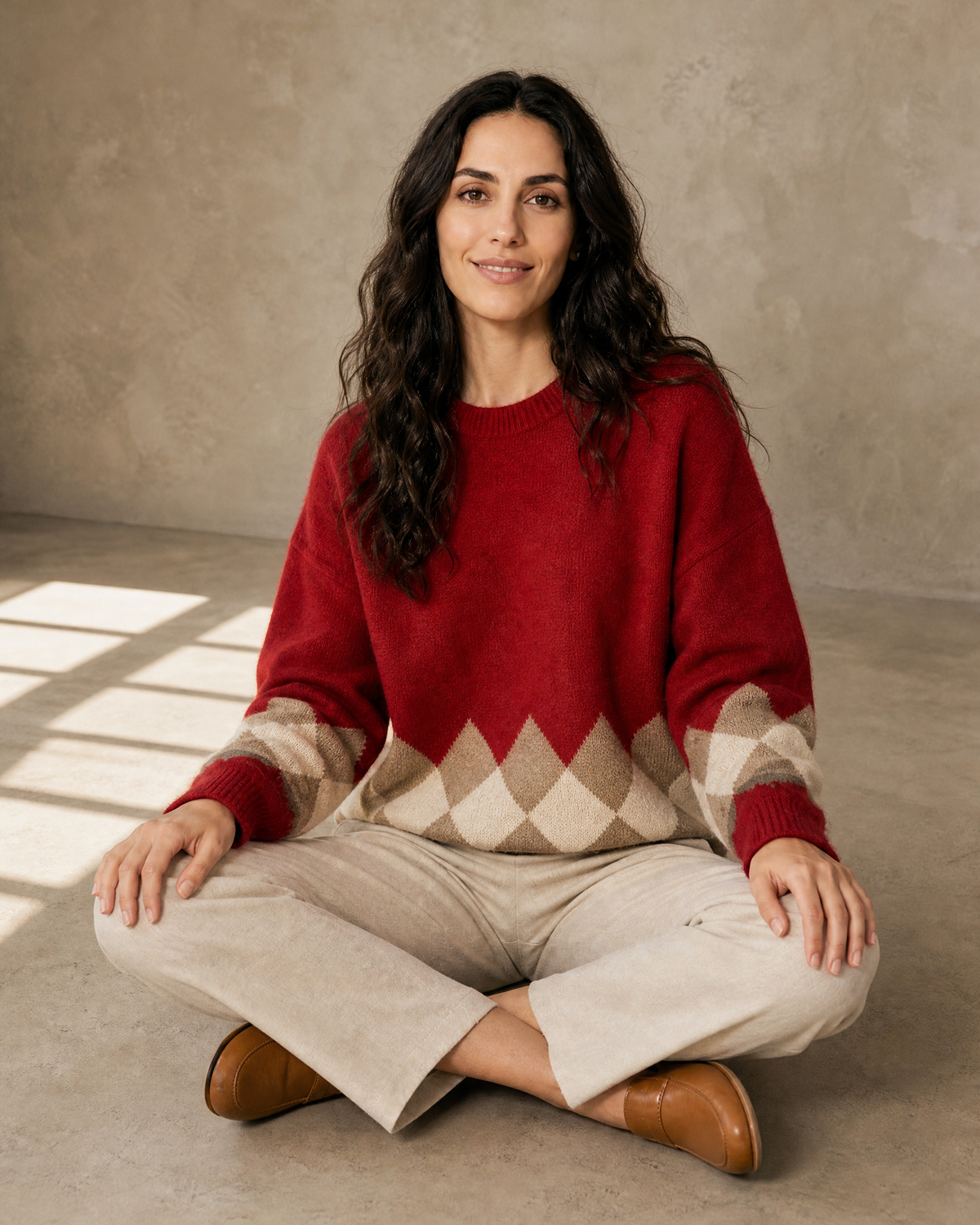 Women's Colour Block Argyle Knit Sweater in Red, floor, cross-legged, worn by model
