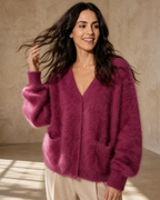 Women's V-Neck Button Cardigan with Pockets in Dark Violet, hair toss mid-motion, worn by model