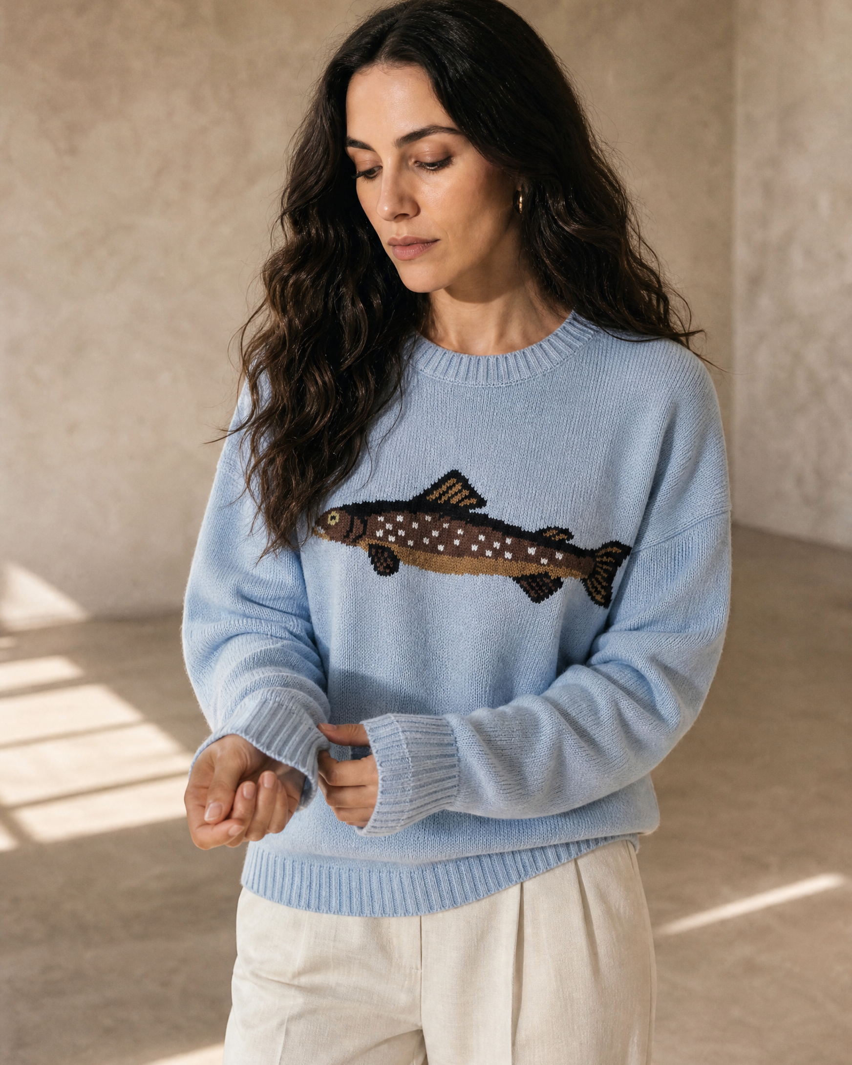 Women's Relaxed Fish Motif Knit Sweater in Blue, cuff detail close-up, worn by model