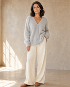 Women's V-Neck Button Cardigan with Pockets in Light Gray, one hand in pocket, half turn, worn by model