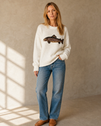 Women's Relaxed Fish Motif Knit Sweater in White, one hand in pocket, half turn, worn by model