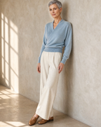 Women's Wrap V-Neck Knit Sweater for Everyday Layering in Stone blue, hip to wall, half profile, worn by model