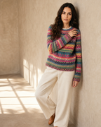 Women's Multicolour Patterned Crew Neck Sweater in Rose Red, wall lean, one hand raised to shoulder, worn by model