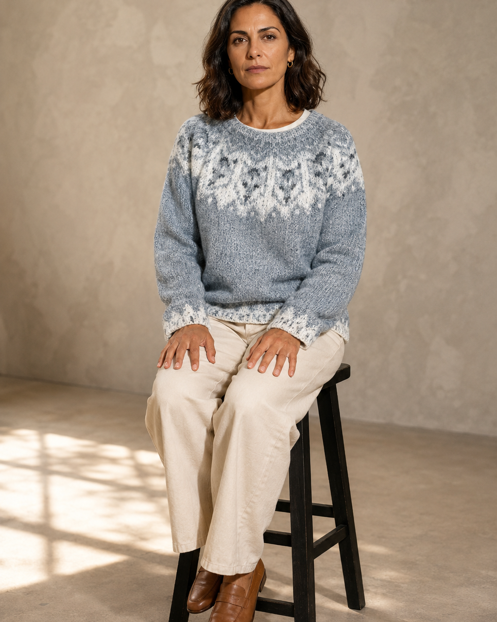 Women's Multicolour Patterned Crew Neck Sweater in Tibetan Wolf, stool, both feet on rung, worn by model