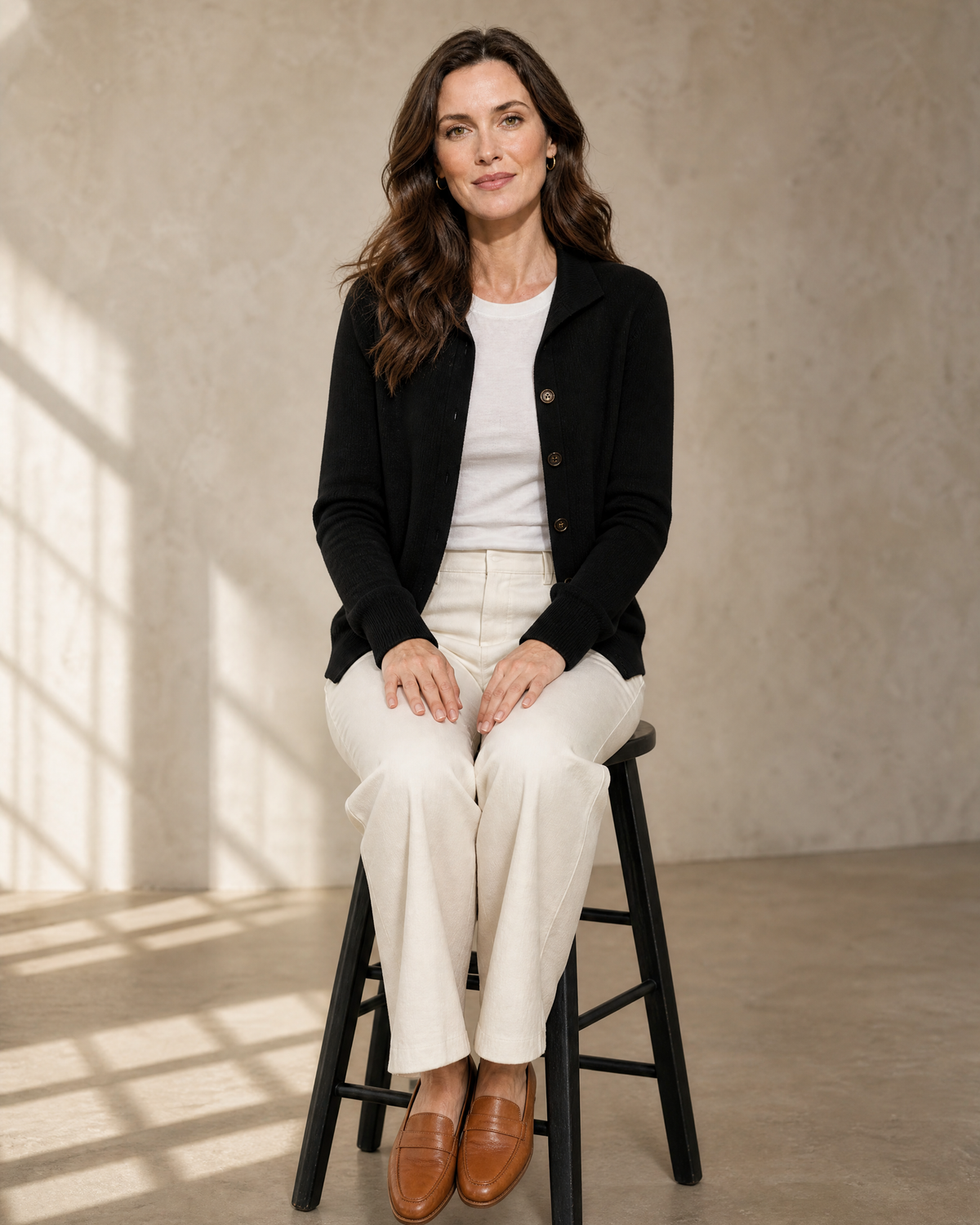 Women's Stand Collar Button Front Cardigan in Black, stool, both feet on rung, worn by model