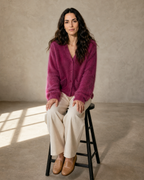Women's V-Neck Button Cardigan with Pockets in Dark Violet, stool, both feet on rung, worn by model