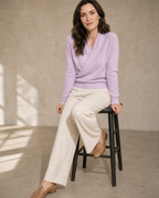 Women's Wrap V-Neck Knit Sweater for Everyday Layering in Lilac purple, stool, leaning back on hands, worn by model