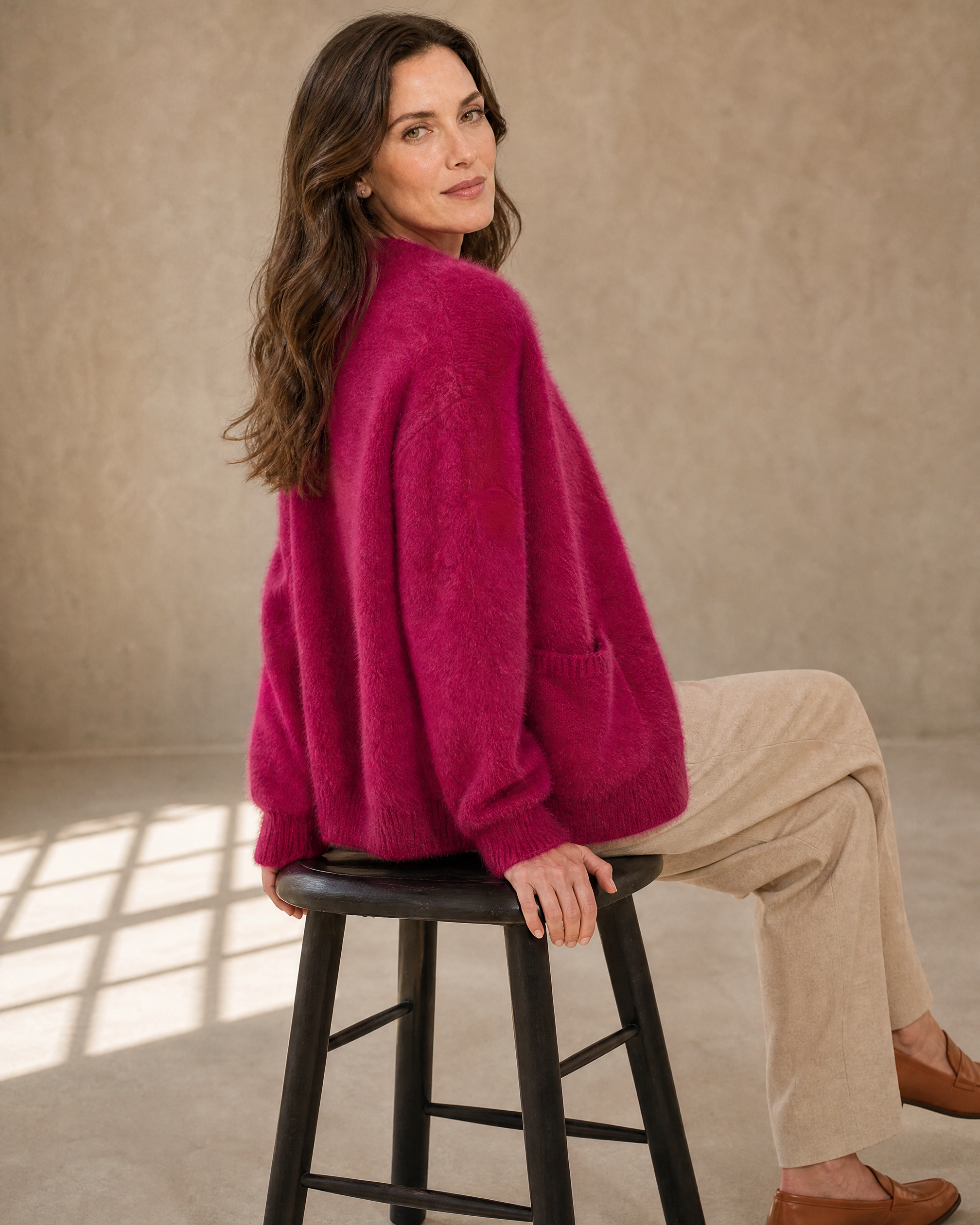 Women's Fuzzy Button Cardigan with Patch Pockets in Rose Red, stool, turned away, head back, worn by model