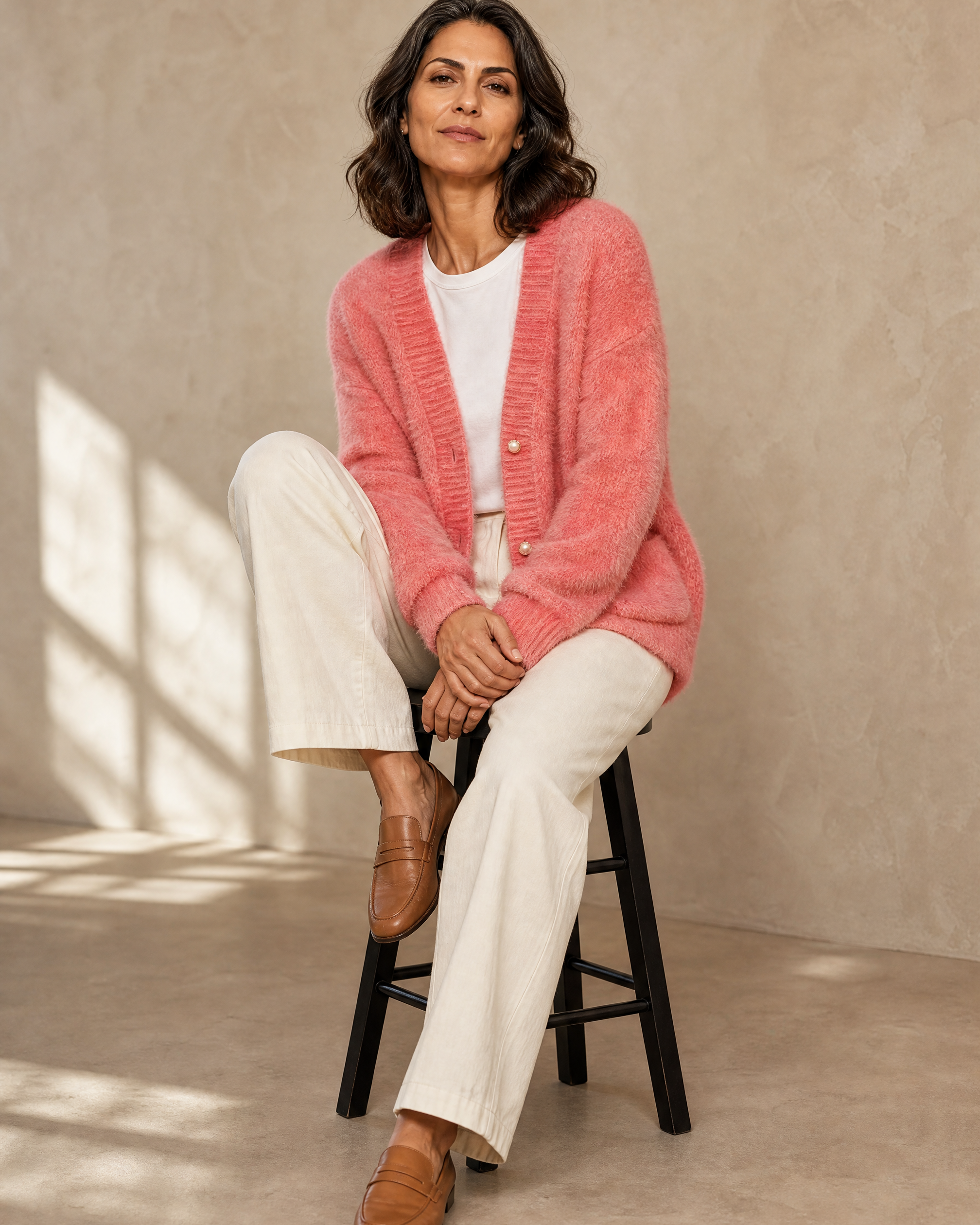 Women's Fuzzy Button Cardigan with Patch Pockets in Pink, stool, one knee drawn up, worn by model