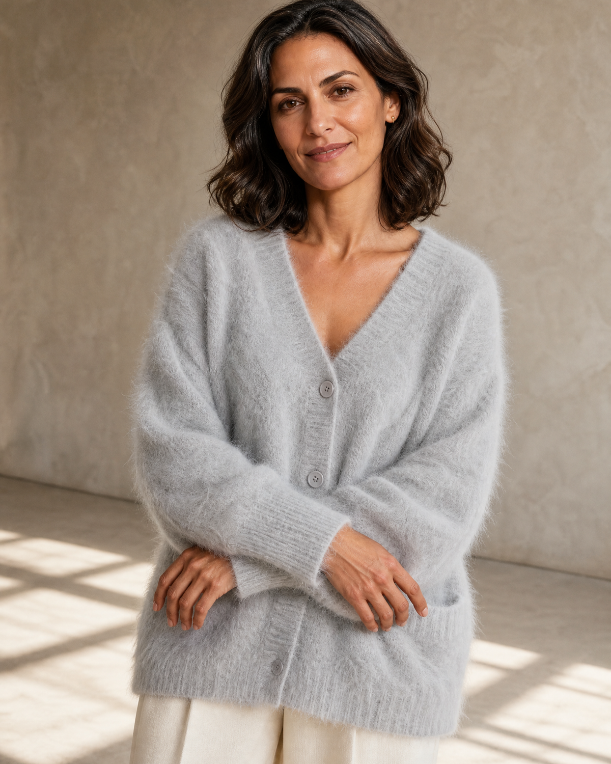 Women's V-Neck Button Cardigan with Pockets in Light Gray, crossed forearms, cuff and hem, worn by model