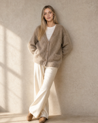 Women's V-Neck Button Cardigan with Pockets in Khaki, wall lean, hands behind hips, worn by model