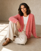 Women's Fuzzy Button Cardigan with Patch Pockets in Pink, floor, one knee up, arm draped, worn by model