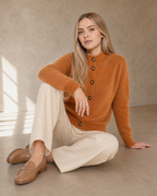 Women's Stand Collar Button Front Cardigan in Caramel Color, floor, one knee up, arm draped, worn by model