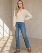 Women's Wrap V-Neck Knit Sweater for Everyday Layering in Vanilla beige, relaxed standing, one hand at hip, worn by model