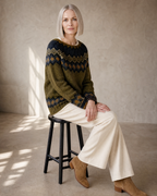 Women's Multicolour Patterned Crew Neck Sweater in Green, stool, side sit with hands on knee, worn by model