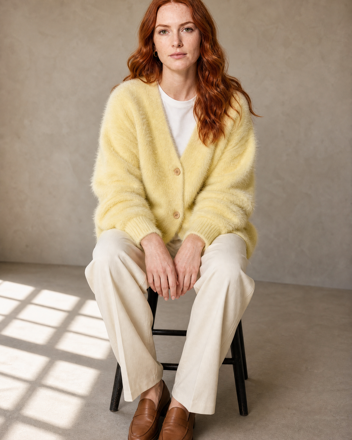 Women's V-Neck Button Cardigan with Pockets in Yellow, stool, forward perch, worn by model