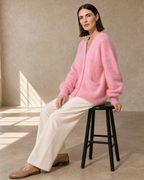 Women's V-Neck Button Cardigan with Pockets in Pink, stool, turned profile, worn by model
