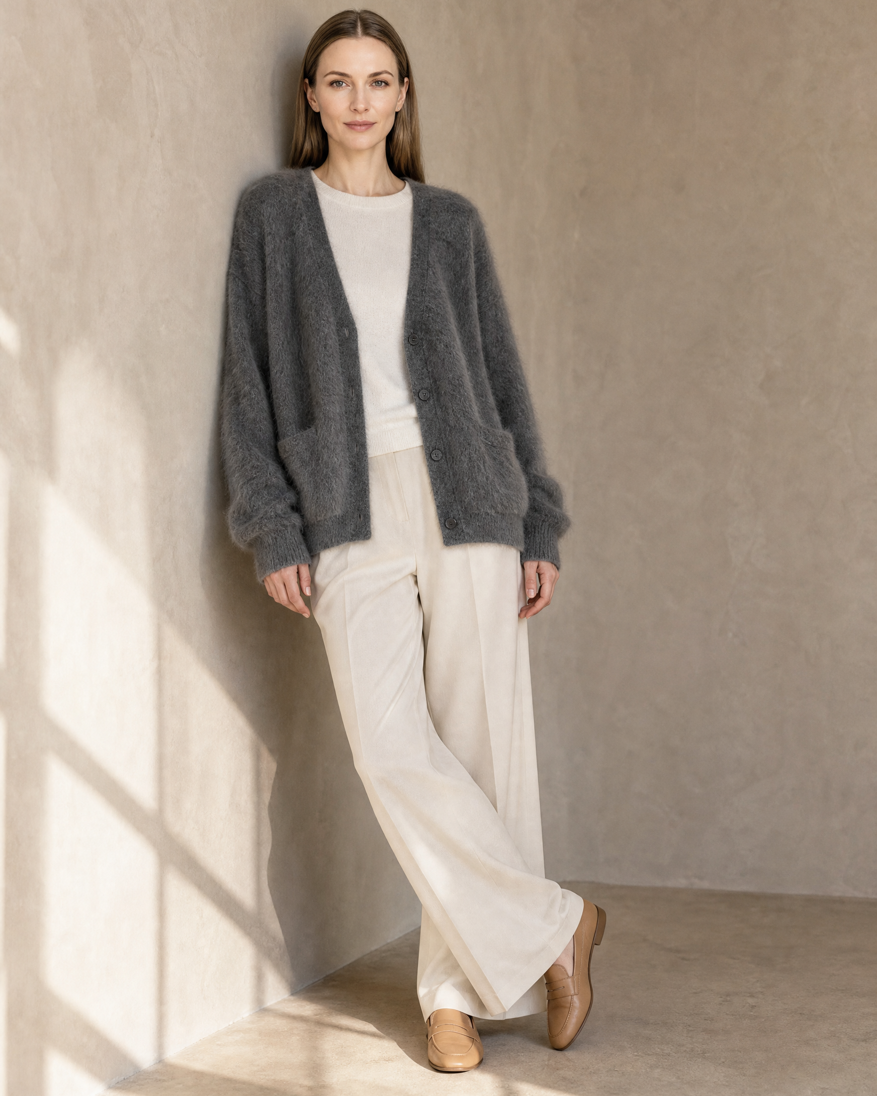 Women's V-Neck Button Cardigan with Pockets in Dark Gray, wall lean, ankles crossed, worn by model