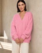 Women's V-Neck Button Cardigan with Pockets in Pink, wall lean, hands loosely joined, worn by model