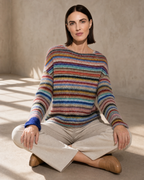 Women's Multicolour Patterned Crew Neck Sweater in Rainbow Bar, floor, cross-legged with open hands, worn by model