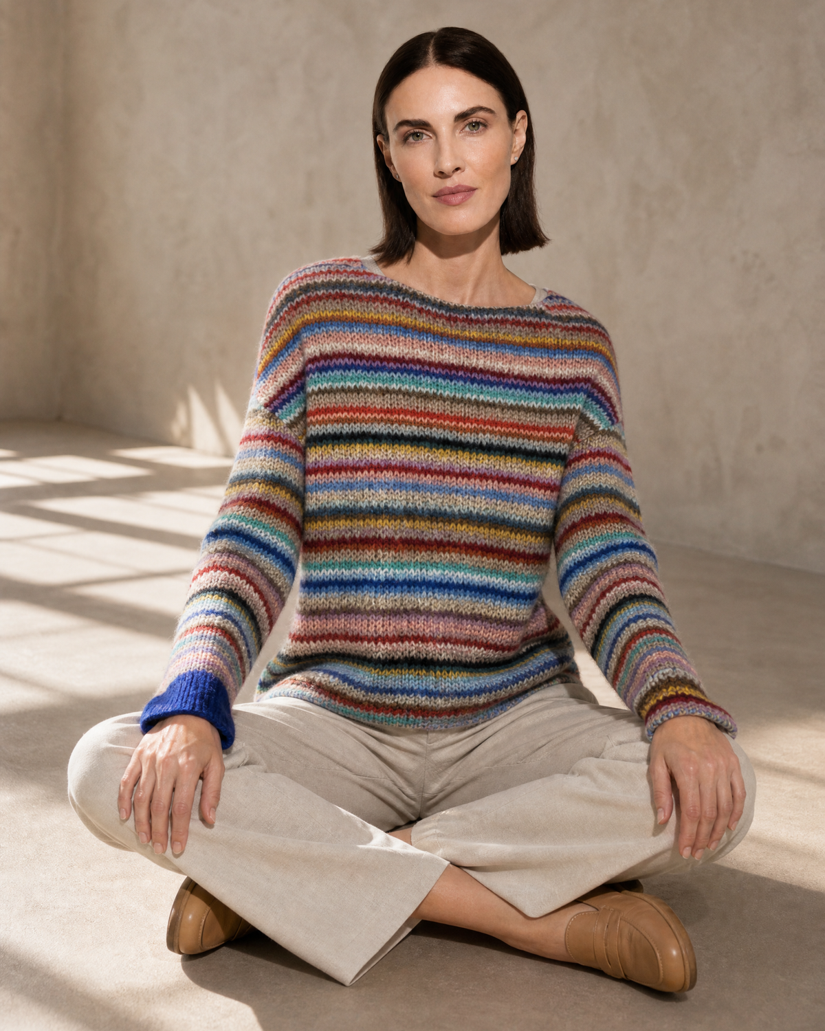 Women's Multicolour Patterned Crew Neck Sweater in Rainbow Bar, floor, cross-legged with open hands, worn by model